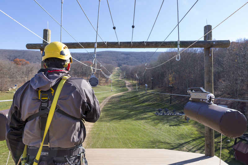 Man looking out from zipline platform.