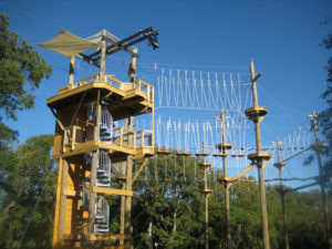 Challenge course tower with extended rope features.