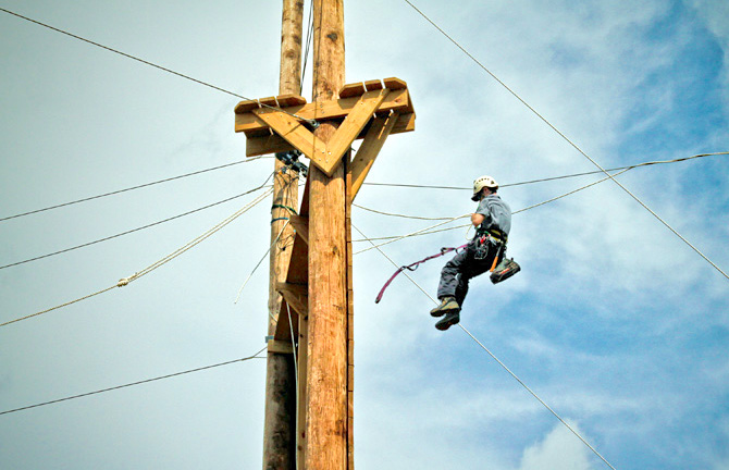 Man repairing a wire in the air.