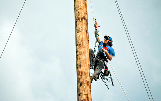 Man repelling from pole.
