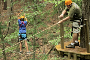 Kid walking across a rope feature.