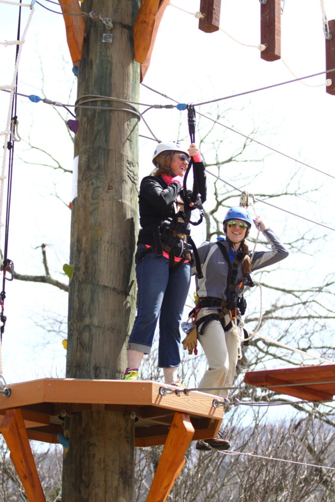 Two people standing on a platform .