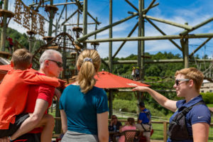 Aerial Park operator showing a family of guests around the aerial park