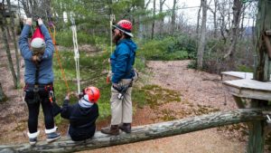 Trainer and Trainees at height in ropes course - rescue lower