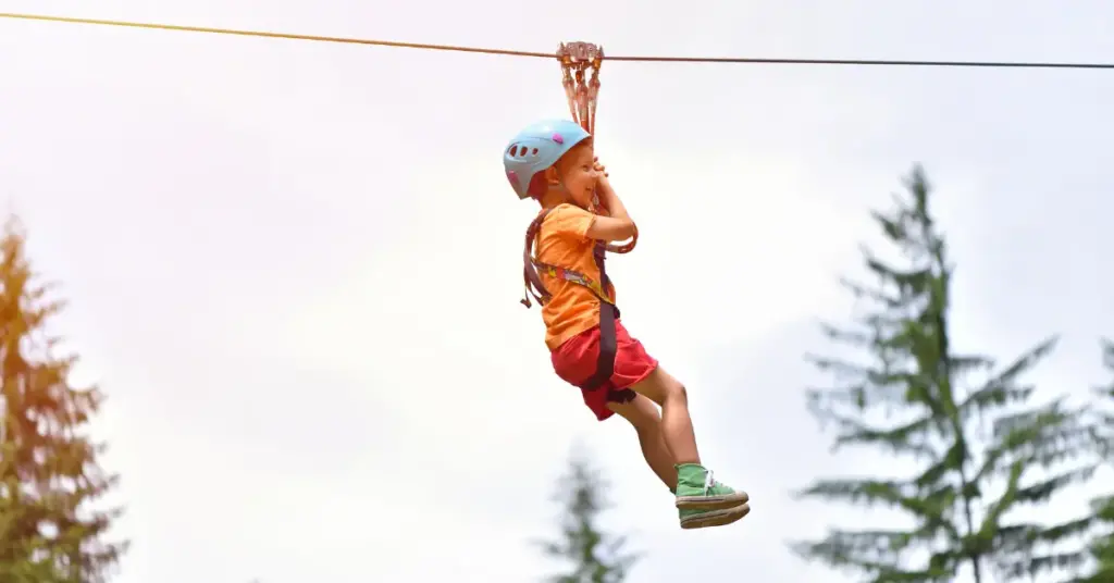 Child on backyard zip line - Challenge Towers